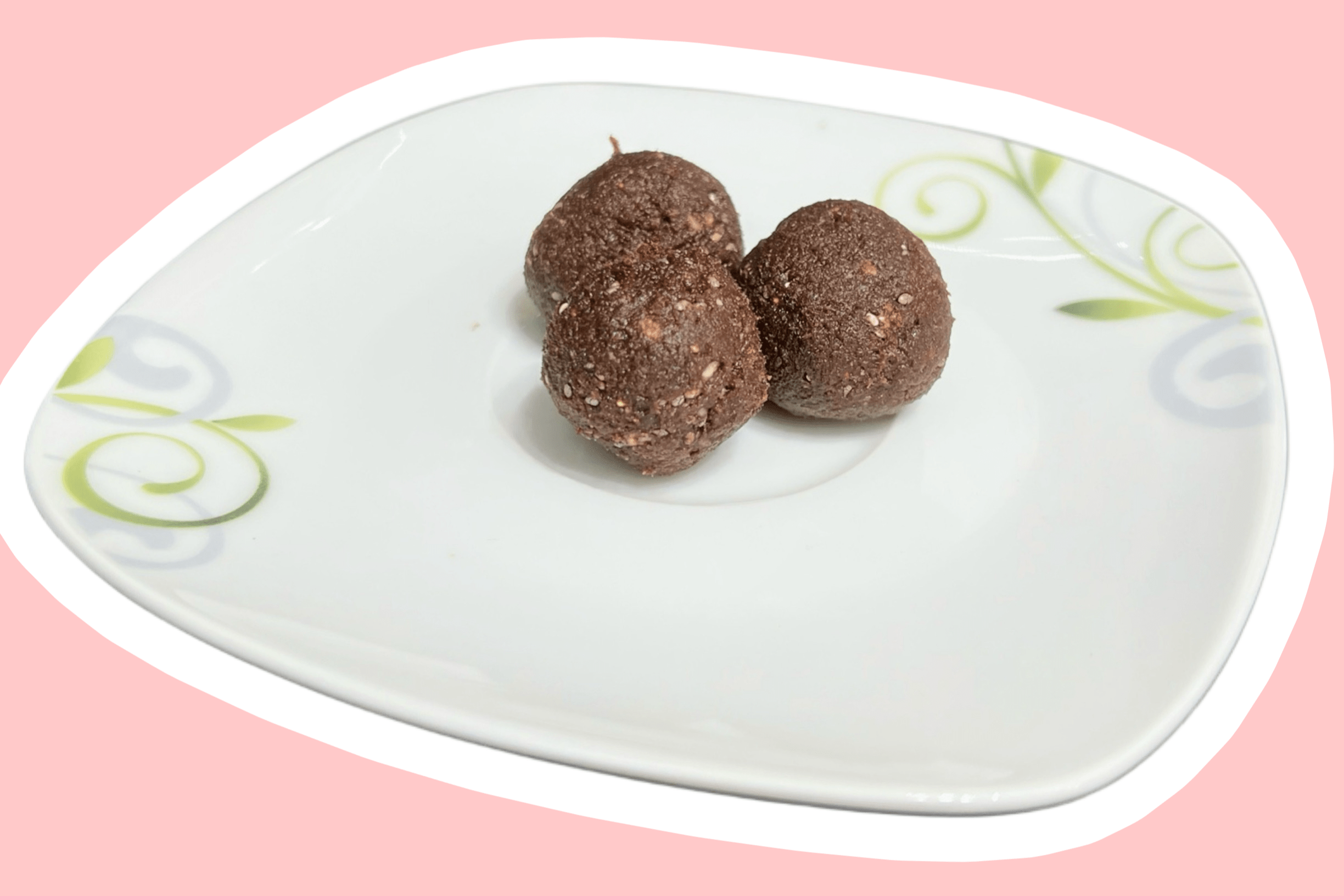 Auf einem kleinen Teller liegen drei köstliche Süßigkeiten: Dattel-Feige-Bällchen mit Kakao.